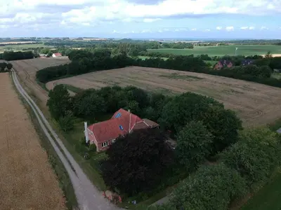 an aerial view of a house in the middle of a field at Cozy property in the countryside in beautiful nature in Vinderup