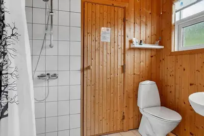 a bathroom with a white toilet and a shower at 1351-Thisted-Mose-Bollevej-13 in Thisted