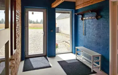 a room with a blue wall with a door and a doorway at 3 Bedroom Amazing Home In Erslev in Erslev
