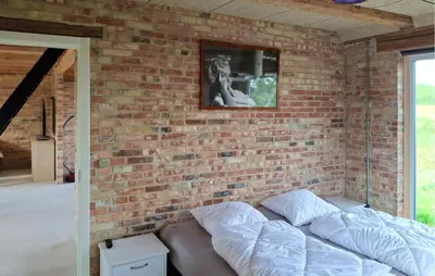 a brick wall with a couch in a room at 3 Bedroom Amazing Home In Erslev in Erslev