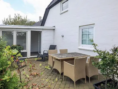 a patio with a table and chairs in front of a house at 6 person holiday home in Thisted in Thisted