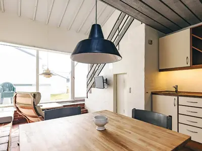 a kitchen and dining room with a wooden table at 6 person holiday home in Brovst in Brovst