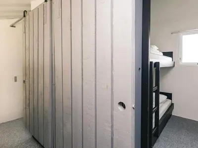 a room with two bunk beds and a door at 6 person holiday home in Brovst in Brovst