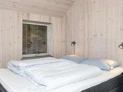 a large white bed in a room with a window at 4 star holiday home in Farsø-By Traum in Farsø
