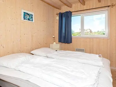 a large white bed in a room with a window at 12 person holiday home in Pandrup-By Traum in Pandrup