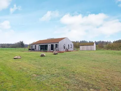 a house in a field with a grass field at 8 person holiday home in Saltum-By Traum in Saltum