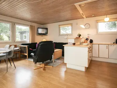 a kitchen and living room with a table and chairs at 5 person holiday home in Thyholm-By Traum in Thyholm