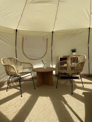 two chairs and a table in a tent at Agger Glamping - Havtornen in Vestervig