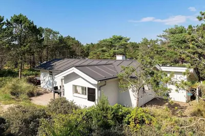 a small white house with a black roof at 1333-Thisted-Sandtornvej-43 in Thisted