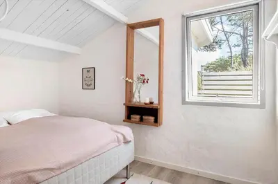 a bedroom with a bed and a window at 1333-Thisted-Sandtornvej-43 in Thisted