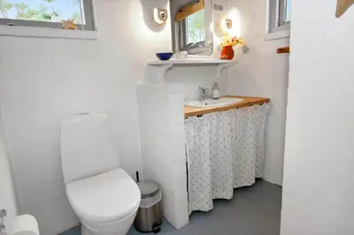 a small bathroom with a toilet and a sink at 1333-Thisted-Sandtornvej-43 in Thisted