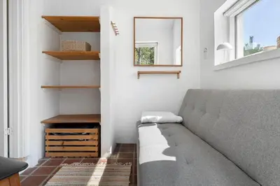 a living room with a couch and a window at 1333-Thisted-Sandtornvej-43 in Thisted