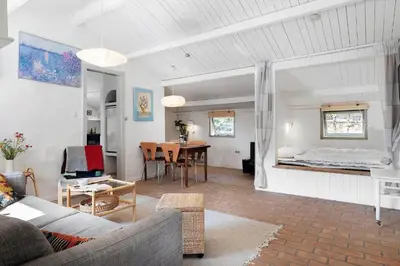 a living room with a couch and a bedroom at 1333-Thisted-Sandtornvej-43 in Thisted