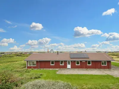 a red house with a solar roof on a field at 10 person holiday home in Harboøre-By Traum in Harboør