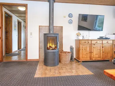 a fireplace in a living room with a tv at 10 person holiday home in Harboøre-By Traum in Harboør
