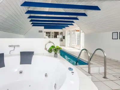 a bath tub in a bathroom with blue beams at 12 person holiday home in Harboøre-By Traum in Harboør