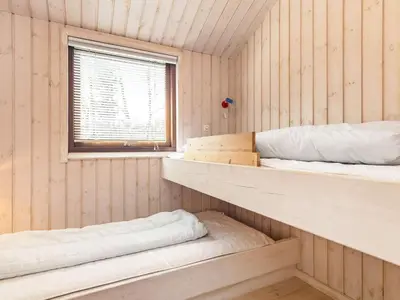 two bunk beds in a room with a window at 8 person holiday home in Fjerritslev-By Traum in Fjerritslev