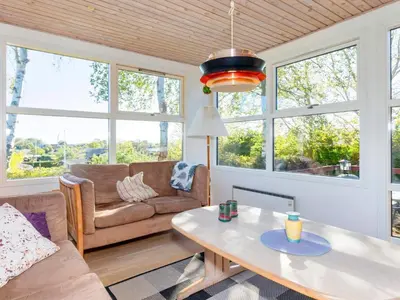 a living room with a couch and a table at 5 person holiday home in Roslev-By Traum in Roslev