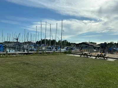 a picnic table next to a marina with boats at Family Cabin By The Calm Waters Of Limfjord in Højslev
