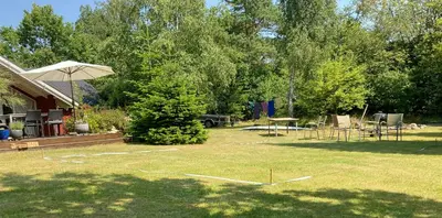 a yard with a picnic table and an umbrella at Family Cabin By The Calm Waters Of Limfjord in Højslev