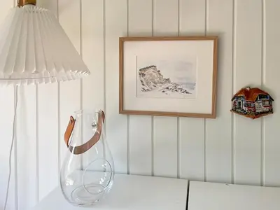 a vase sitting on a table next to a lamp at Holiday Home By Limfjord With Historic Charm in Farsø