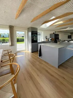 a kitchen with a large island in a room at Summer House With Wilderness Bath And Water Views in Vinderup