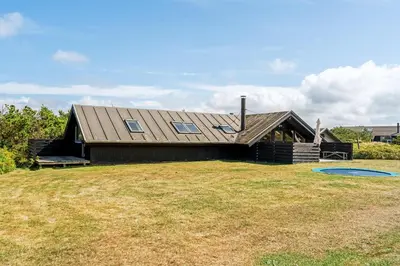 a house with a large yard in front of it at Lovely Holiday Home With Wood-Burning Stove, Close To The North Sea In Klitmøller in Thisted