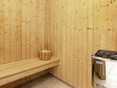 a wood paneled kitchen with a wooden wall at 8 person holiday home in Brovst-By Traum in Brovst