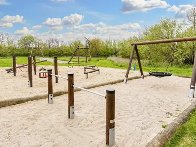 a playground with two swings and a swing at 12 person holiday home in Vestervig-By Traum in Vestervig