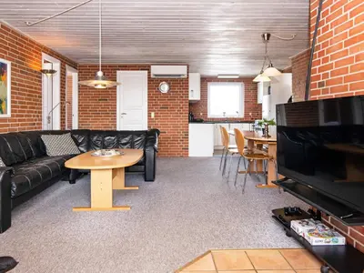 a living room with a couch and a table at 8 person holiday home in Harboøre-By Traum in Harboør