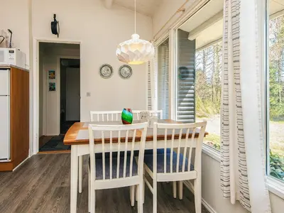 a dining room with a table and chairs and a window at 5 person holiday home in Højslev-By Traum in Højslev