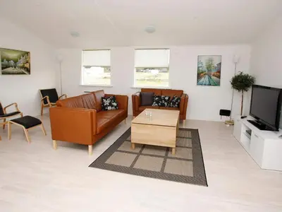 a living room with two couches and a tv at 16 person holiday home in Brovst-By Traum in Brovst