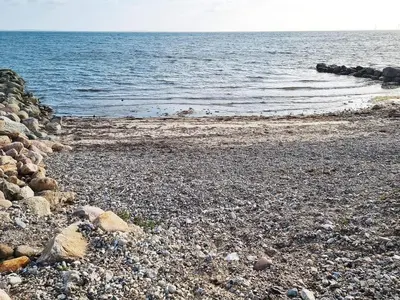 a rocky beach with rocks and the water at 7 person holiday home in Hurup Thy-By Traum in Sønder Ydby