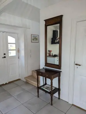 a mirror sitting on a table in a room at Strandhuset in Agger