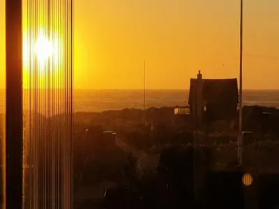 a view of the sunset from a building at Holiday Home Tekla - 180m from the sea by Interhome in Blokhus