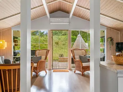 a living room with a table and chairs at Holiday Home Nahuel - 1km from the sea by Interhome in Blokhus