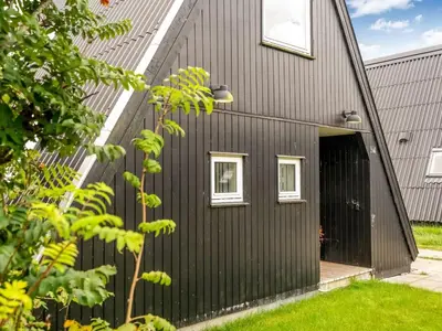 a black house with a black door at Holiday Home Ernstine by Interhome in Farsø