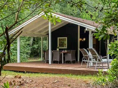 a porch with a table and chairs on a deck at Holiday Home Melisa - 3km from the sea by Interhome in Pandrup