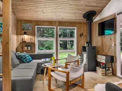 a living room with a couch and a table at Holiday Home Melisa - 3km from the sea by Interhome in Pandrup