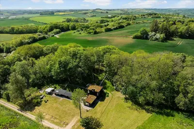 an overhead view of a house in a field with trees at Summer House Close To Nature By The Limfjord in Nykøbing Mors