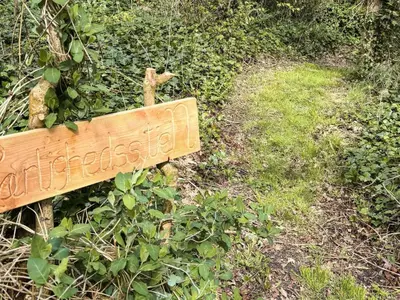 a wooden sign on the side of a trail at 10 person holiday home in Vinderup-By Traum in Vinderup