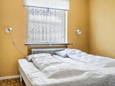 an unmade bed in a bedroom with a window at 4 person holiday home in Bøvlingbjerg in Bøvlingbjerg