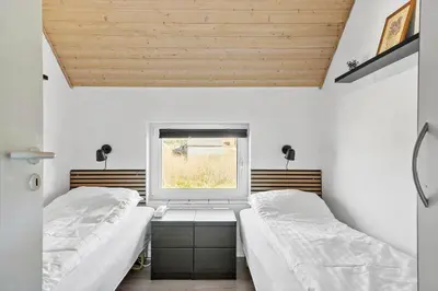 two beds in a room with a window at 288-Harboore-Doblervej-15 in Harboør