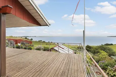 a wooden deck with a view of the ocean at G295-Lemvig-Syrenvej-95 in Lemvig