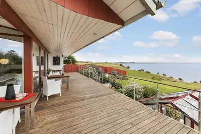 a balcony of a house with a view of the ocean at G295-Lemvig-Syrenvej-95 in Lemvig