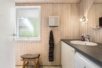 a bathroom with a sink and a window at LK1123-Lokken-Piasvej-16 in Løkken