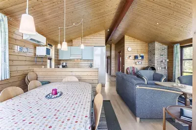 a kitchen and living room with a table and chairs at LK316-Lokken-Sarasvej-22 in Løkken
