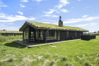 a house with a grass roof on a field at LK316-Lokken-Sarasvej-22 in Løkken