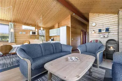 a living room with blue couches and a table at LK316-Lokken-Sarasvej-22 in Løkken