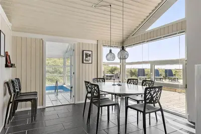 a dining room with a table and chairs at LK1001-Lokken-Nellysvej-21 in Løkken